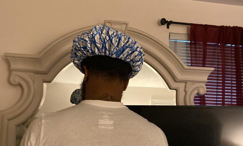 Customer wearing a blue patterned satin bonnet